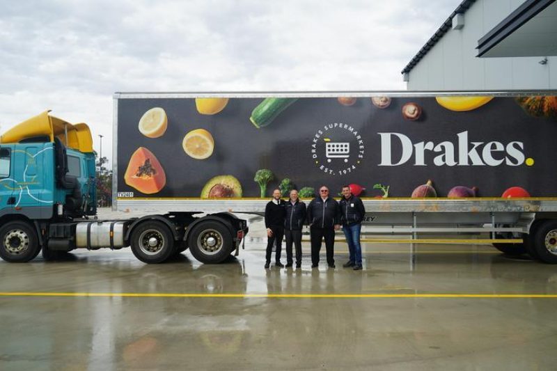 Jp drake director roger drake ceo bob soang general manager glenn sutcliffe logistics manager standing in front of drakes truck